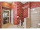 Bathroom with floral wallpaper, tiled floor, toilet, and shower at 18502 Winding Oaks Blvd, Hudson, FL 34667