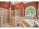 Bathroom with floral wallpaper, tiled floor, walk in shower, and large tub at 18502 Winding Oaks Blvd, Hudson, FL 34667