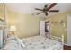 Light-filled bedroom with a decorative ceiling fan and access to other rooms at 18502 Winding Oaks Blvd, Hudson, FL 34667