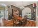 Formal dining room featuring dark floral wallpaper and a stylish chandelier at 18502 Winding Oaks Blvd, Hudson, FL 34667