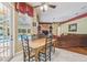 Dining room features a wood table with a pool view through a patio door at 18502 Winding Oaks Blvd, Hudson, FL 34667