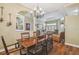 Open concept view of the dining and living areas featuring hardwood floors at 18502 Winding Oaks Blvd, Hudson, FL 34667