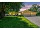 Inviting single-story home with a three-car garage, well-manicured lawn, and a paver driveway at 18502 Winding Oaks Blvd, Hudson, FL 34667
