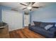 This flex room features laminate wood floors, a ceiling fan, a comfy couch and built in closet storage at 18502 Winding Oaks Blvd, Hudson, FL 34667