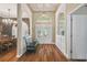 Inviting foyer with hardwood floors, archways, and decorative glass front doors at 18502 Winding Oaks Blvd, Hudson, FL 34667