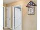 Neutral-toned hallway with white doors and tile floor at 18502 Winding Oaks Blvd, Hudson, FL 34667