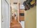 Hallway featuring hardwood floors leading to the kitchen, dining room and pantry at 18502 Winding Oaks Blvd, Hudson, FL 34667