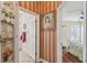 Hallway view with charming decor leading to a bedroom and bathroom at 18502 Winding Oaks Blvd, Hudson, FL 34667