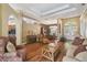 Open living room with hardwood floors, coffered ceilings, and decorative archways at 18502 Winding Oaks Blvd, Hudson, FL 34667