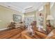 Comfortable living room with hardwood floors, a view of the backyard, and tray ceilings at 18502 Winding Oaks Blvd, Hudson, FL 34667