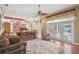 Open concept living room with hardwood floors, large sofas, and access to kitchen and pool area at 18502 Winding Oaks Blvd, Hudson, FL 34667