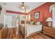 The primary bedroom has hardwood floors, neutral paint and a four poster bed to call your own at 18502 Winding Oaks Blvd, Hudson, FL 34667