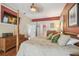 A large main bedroom is complimented by a large screen TV, hardwood floors, and plenty of space to roam at 18502 Winding Oaks Blvd, Hudson, FL 34667