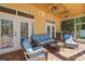 Covered patio with ample seating, outdoor grill, and brick flooring with pool view at 18502 Winding Oaks Blvd, Hudson, FL 34667