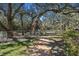 Community playground featuring mature trees, benches, swings, and a slide at 18502 Winding Oaks Blvd, Hudson, FL 34667