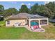 Aerial view of a screened-in pool, patio area, and outdoor seating with a well maintained backyard and mature landscaping at 18502 Winding Oaks Blvd, Hudson, FL 34667