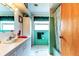 Bright bathroom features a vanity sink, mirror, tile, and shower at 1919 Harpoon Dr, Holiday, FL 34690
