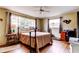 Comfortable bedroom with wood floors, ceiling fan, and natural light at 1919 Harpoon Dr, Holiday, FL 34690