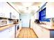 Bright kitchen featuring white cabinets, modern appliances, and efficient layout at 1919 Harpoon Dr, Holiday, FL 34690
