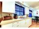Bright kitchen featuring white cabinets, stainless steel sink, and modern appliances at 1919 Harpoon Dr, Holiday, FL 34690