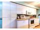 Bright kitchen featuring white cabinetry, modern appliances, and ample storage at 1919 Harpoon Dr, Holiday, FL 34690