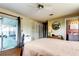 Comfortable bedroom features a ceiling fan, closet, and en-suite bathroom at 1919 Harpoon Dr, Holiday, FL 34690