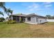 Exterior view of the home, showcasing a landscaped yard and screened in patio at 22118 Yachtclub Ter, Land O Lakes, FL 34639