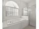 Bright bathroom featuring a soaking tub with jets and a glass-enclosed shower at 22118 Yachtclub Ter, Land O Lakes, FL 34639