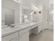 All-white bathroom with double sinks, a large mirror, and ample counter space at 22118 Yachtclub Ter, Land O Lakes, FL 34639