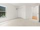 Carpeted bedroom featuring a double door closet and large window with greenery views at 22118 Yachtclub Ter, Land O Lakes, FL 34639