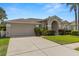Well-maintained single-story home with manicured landscaping, ample driveway space, and a two-car garage at 22118 Yachtclub Ter, Land O Lakes, FL 34639