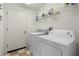 Functional laundry room with washer, dryer, and shelving for storage at 22118 Yachtclub Ter, Land O Lakes, FL 34639