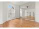 Bright living room featuring wood floors, high ceilings, and large mirrors creating an open and airy space at 22118 Yachtclub Ter, Land O Lakes, FL 34639