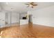 Spacious living room with ceiling fan, archways, tile kitchen flooring, and access to other rooms at 22118 Yachtclub Ter, Land O Lakes, FL 34639