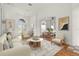 Bright living room featuring an open layout and contemporary furnishings, seamlessly connected to the dining area at 22118 Yachtclub Ter, Land O Lakes, FL 34639
