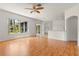Inviting living room featuring wood flooring and a large window with backyard views at 22118 Yachtclub Ter, Land O Lakes, FL 34639