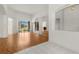 Spacious living room with hardwood floors, white walls, and a sliding glass door overlooking the outdoors at 22118 Yachtclub Ter, Land O Lakes, FL 34639