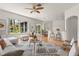 Sunlit living room boasts stylish decor, a comfortable seating area, and an open view to the adjacent dining space at 22118 Yachtclub Ter, Land O Lakes, FL 34639