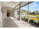 Screened patio with tile floor, ceiling fan, and views of the backyard at 22118 Yachtclub Ter, Land O Lakes, FL 34639