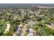 Scenic aerial view of a community with lush greenery, golf course, and serene lake views at 2327 Morning Glory Trl, Spring Hill, FL 34606