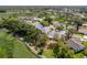 Aerial shot of a community with lush landscaping, a golf course, and scattered trees at 2327 Morning Glory Trl, Spring Hill, FL 34606