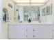 Bathroom featuring dual sinks, large mirror and a shower at 2327 Morning Glory Trl, Spring Hill, FL 34606