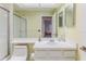 Bright bathroom featuring a vanity with sink and ample counter space, with a view of the shower and toilet at 2327 Morning Glory Trl, Spring Hill, FL 34606
