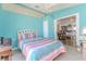 Bedroom with turquoise walls, light tile floors, a ceiling fan, and a doorway to another room at 2327 Morning Glory Trl, Spring Hill, FL 34606