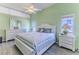 Bright bedroom featuring hardwood floors, a large window for natural light, and neutral walls at 2327 Morning Glory Trl, Spring Hill, FL 34606