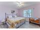 Comfortable bedroom with soft lighting, a ceiling fan, and a serene ambiance at 2327 Morning Glory Trl, Spring Hill, FL 34606