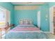Bedroom featuring bright turquoise walls, light tile floors, and light-colored trim at 2327 Morning Glory Trl, Spring Hill, FL 34606