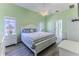 Bright bedroom featuring hardwood floors, a large window for natural light, and neutral walls at 2327 Morning Glory Trl, Spring Hill, FL 34606