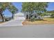Charming single Gathering home featuring a well maintained lawn, mature trees and a three car garage at 2327 Morning Glory Trl, Spring Hill, FL 34606