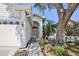 Close-up view of the home's entrance, brick walkway and well-maintained landscaping at 2327 Morning Glory Trl, Spring Hill, FL 34606